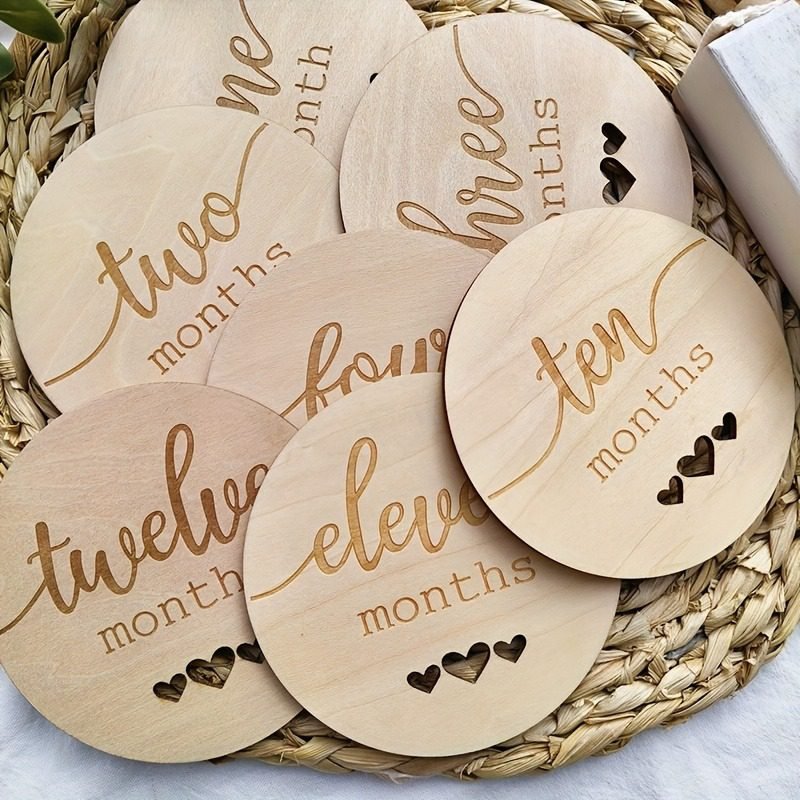 Wooden baby monthly milestone discs with heart cutouts