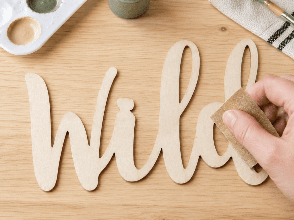 sanding wooden craft before painting