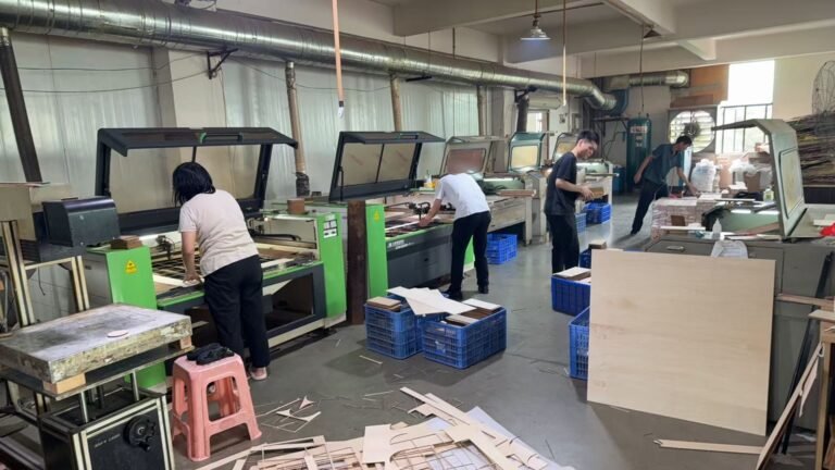 Worker operating laser cutting equipment for wooden crafts production